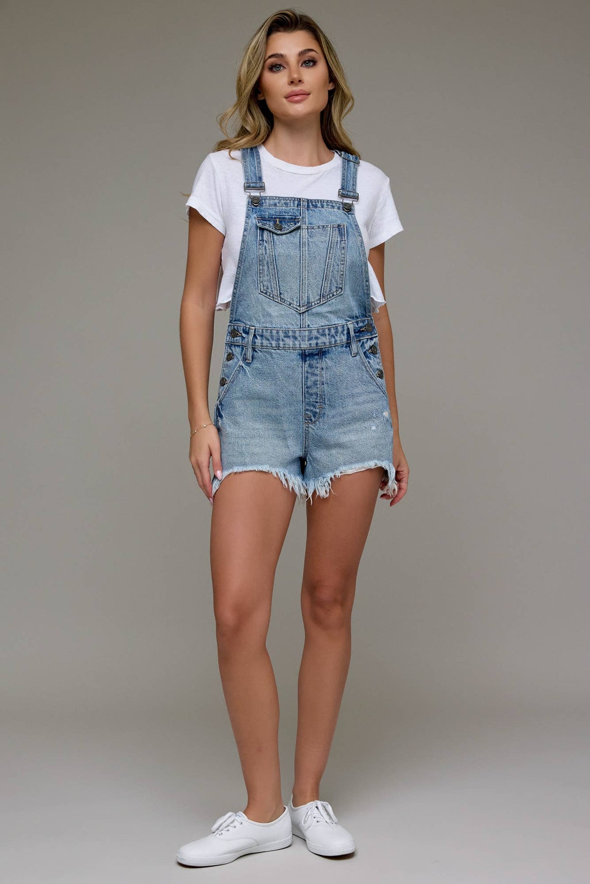 The Sonya Medium Wash Frayed Hem Overall shorts
